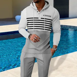 Detail of men's waffle knit color block hoodie and joggers set in a poolside setting