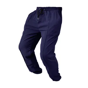 Close-up detail of navy blue waffle knit joggers with elastic drawstring waistband