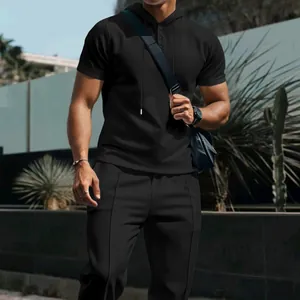 Detailed view of men's black waffle knit hooded short-sleeve top and trousers set