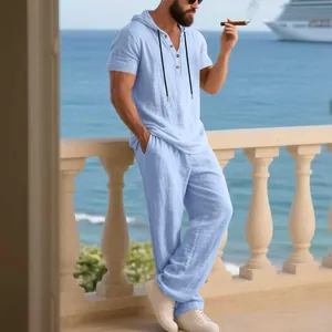 Detail view of men's light blue linen hooded Henley shirt and loose pants set