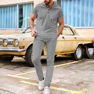 Men's grey waffle knit 2-piece set featuring short sleeve hooded top and matching pants.