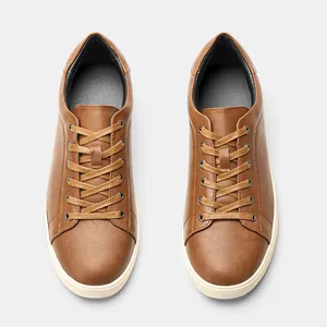Vista dall'alto di sneakers casual marroni basse classiche da uomo con suole bianche