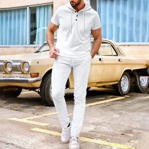 Detail view of men's white waffle knit two-piece set in a vintage street setting