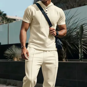 Close-up of men's waffle knit hooded short-sleeve top and matching pants set in beige