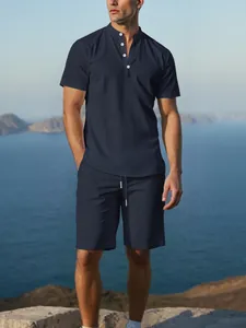 Detailed view of men's navy blue cotton linen Henley shirt and shorts set outdoors