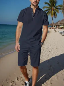 Casual men's navy blue cotton linen Henley shirt and shorts set styled on a beach