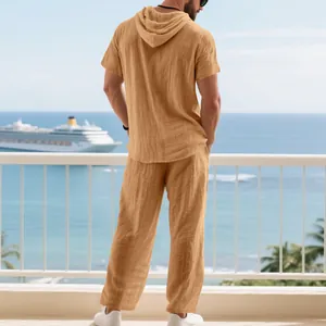 Detailed rear view of men's casual brown linen hooded t-shirt and loose pants set.