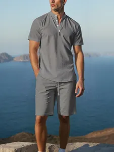 Detail showing the linen fabric texture of the grey Henley shirt and shorts set