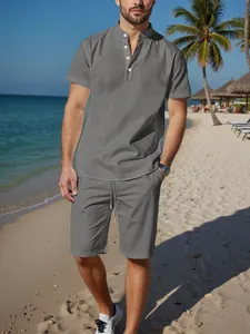 Detailed view of a man wearing a grey cotton linen Henley shirt and shorts set at the beach