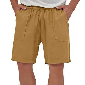 Detail view of men's mustard cotton linen shorts featuring drawstring waist and large pockets.