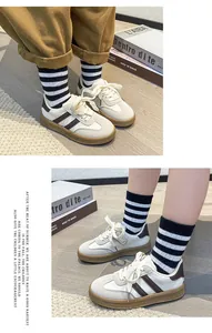 Detailed view of kids vintage sneakers with brown stripes and gum rubber soles