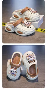 Detailed view of girls' cream clogs with cute rabbit sports charms and non-slip soles.