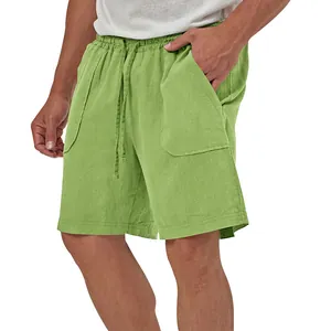 Close-up of men's lime green cotton linen shorts with drawstring and patch pockets.