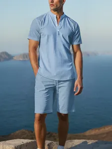 Detail of light blue men's cotton linen short-sleeve Henley shirt and matching shorts