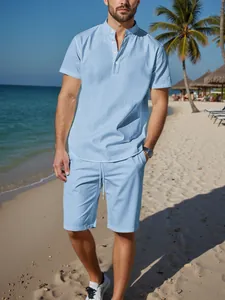 Detailed view of men's light blue cotton linen short sleeve Henley shirt set on beach