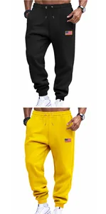 Detail view of men's American style loose drawstring sweatpants in black and yellow