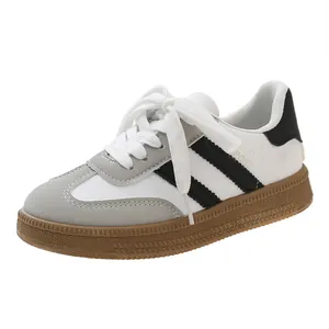 Vintage style white German Army Trainers for women featuring grey suede and a gum sole