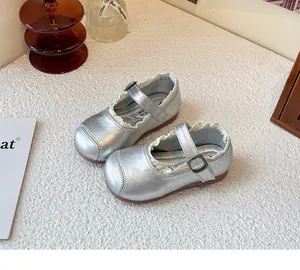 Close-up of silver girls' Mary Jane shoes with delicate white lace trim and buckle