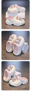 Detailed studio views of girls' cream and pink cartoon clogs with cute rabbit charms.