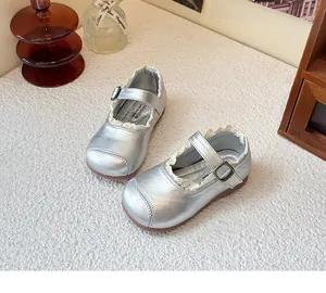 Elegant silver girls' Mary Jane shoes with delicate lace trim and adjustable buckle strap.