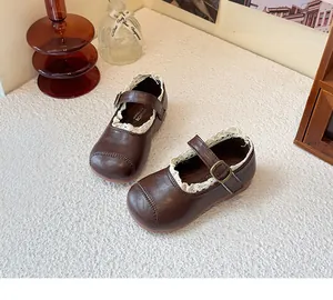 Classic brown girls princess shoes with white lace trim and adjustable buckle strap