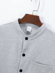 Close-up of a grey waffle-knit shirt showing the mandarin collar and fabric texture