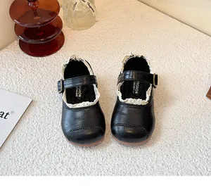 Detailed top view of black girl's Mary Jane shoes with delicate white lace trim