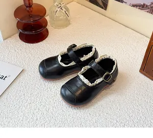 Close-up of black girl's Mary Jane princess shoes with delicate white lace trim detail.
