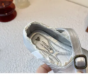 Detailed close-up of silver girls' Mary Jane shoes with elegant lace trim and buckle