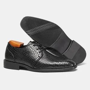 Dettaglio scarpe eleganti nere motivo coccodrillo con suola in gomma antiscivolo