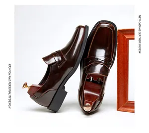 High-shine brown leather penny loafers with square toe and elegant stitching detail