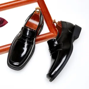 Classic black patent leather men's loafers with square toe and slip-on design for business.