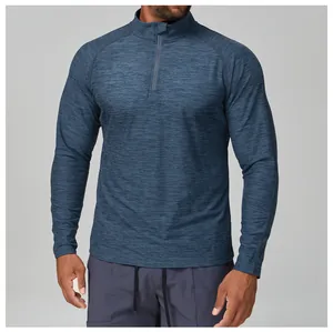 Detail shot of blue heathered half-zip athletic long sleeve shirt for men, showing fabric texture.