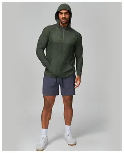 Close-up of green quick-dry hooded fitness jacket for men with 1/4 zip design.