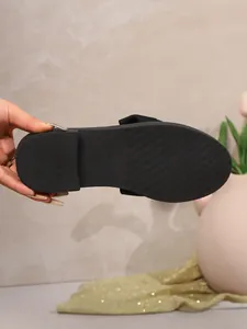 Detail view of the anti-slip textured sole of a black retro bow loafer, size 37.