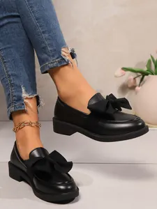 Classic black bow loafers for women with vintage preppy style and thick platform heels