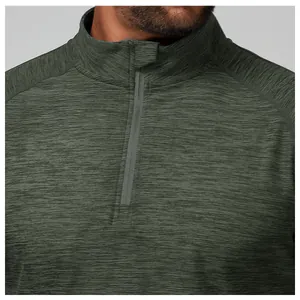 Close-up of men's dark green half-zip sports shirt showing quick-dry fabric texture