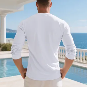 Back view of a premium white long-sleeved men's cotton T-shirt in a luxury outdoor setting