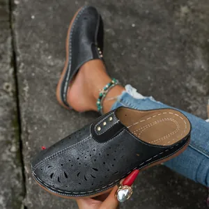 Vintage black hollow-out closed-toe clogs for women featuring chic metallic details