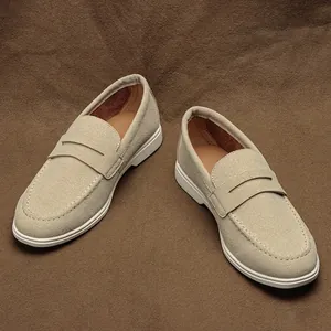 Stylish men's beige suede loafers with slip-on design and white casual flat sole