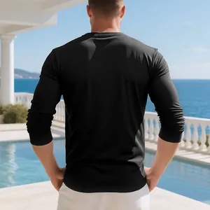 Detailed rear view of a men's black long-sleeved casual Henley shirt at a resort