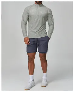 Men's slim fit grey long-sleeved athletic top and navy blue quick-dry training shorts