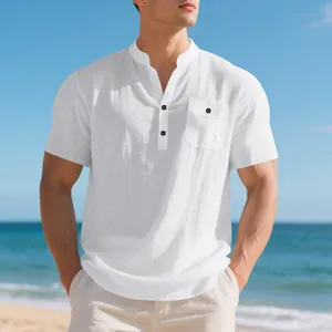 Men's white summer linen short sleeve Henley shirt with a buttoned pocket on the beach
