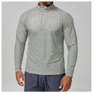 Close-up detail of grey men's slim fit half-zip athletic long sleeve shirt in quick-dry fabric