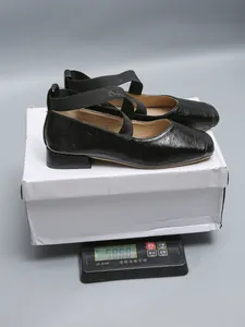 Detail showing weight measurement of black square-toe Mary Jane flats with straps.