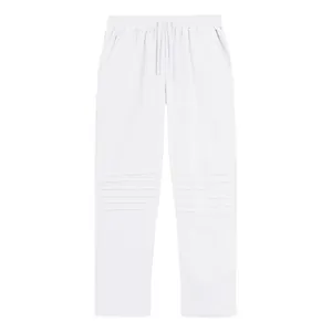 Detailed front view of white loose linen trousers with distinctive pleated knee design