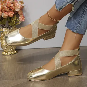 Detailed view of gold metallic square toe ballet flats with elastic cross straps