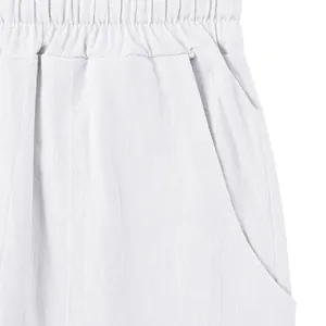 Close-up detail of elastic waistband and side pocket on white linen pants for men