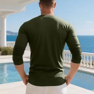 Back view of a men's olive green long-sleeved slim-fit T-shirt by the outdoor pool