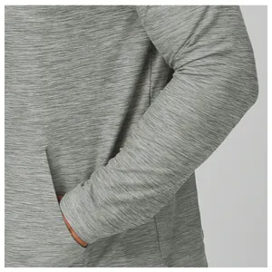 Macro detail of grey heather quick-dry fabric on long sleeve athletic hiking jacket